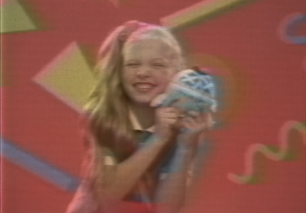 Quinn Newman holding a toy in the Poppy Playtime Chapter 5 commercial